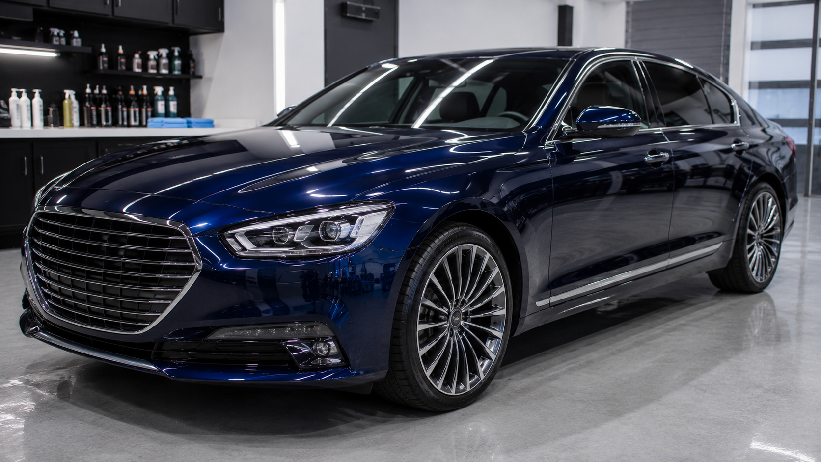 Brand new dark blue luxury sedan inside a professional detailing studio for ceramic coating installation